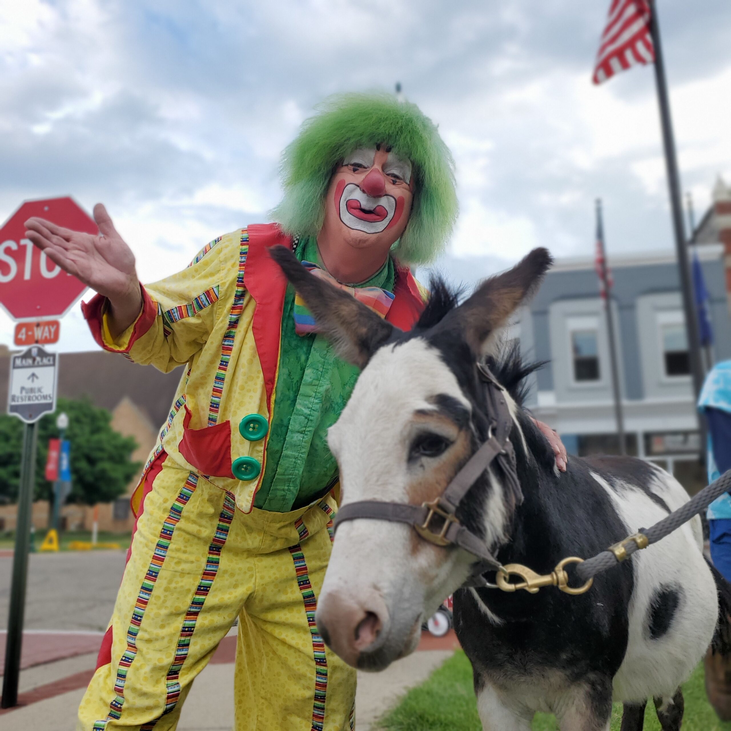 a clown holding a donkey